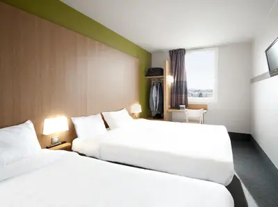 Un ou plusieurs lits dans un hébergement de l'établissement B&B HOTEL Lyon Vénissieux