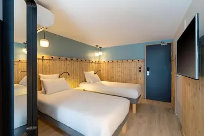 Un ou plusieurs lits dans un hébergement de l'établissement Best Western Bourgoin Jallieu