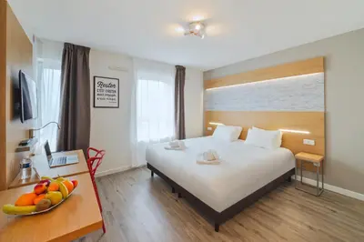 Un ou plusieurs lits dans un hébergement de l'établissement Residhotel Lyon Part Dieu