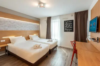 Un ou plusieurs lits dans un hébergement de l'établissement Residhotel Lyon Part Dieu