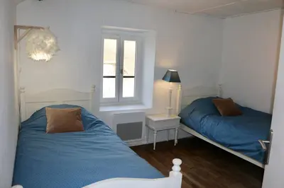 Un ou plusieurs lits dans un hébergement de l'établissement Maison Spacieuse à Boulieu