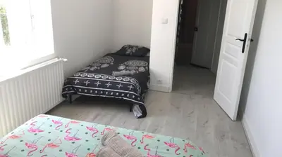 Un ou plusieurs lits dans un hébergement de l'établissement Bald'Home côté jardin