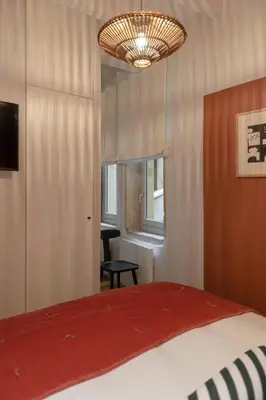 Un ou plusieurs lits dans un hébergement de l'établissement MiHotel Saint Jean