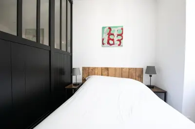 Un ou plusieurs lits dans un hébergement de l'établissement L'Arty - Très joli studio moderne place Valmy