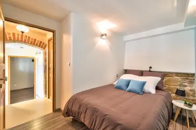 Un ou plusieurs lits dans un hébergement de l'établissement Appartement Le Cosy - Calme & Chaleureux - Bien situé