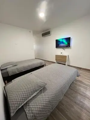 Un ou plusieurs lits dans un hébergement de l'établissement Superbe appartement à 15 min de Lyon